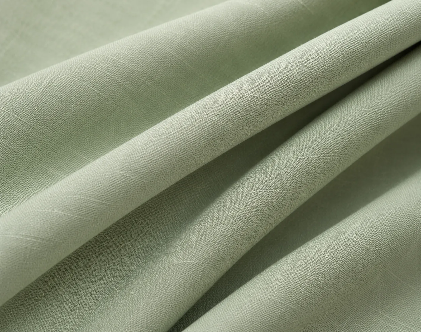 Softly draped sage green fabric with a subtle woven texture