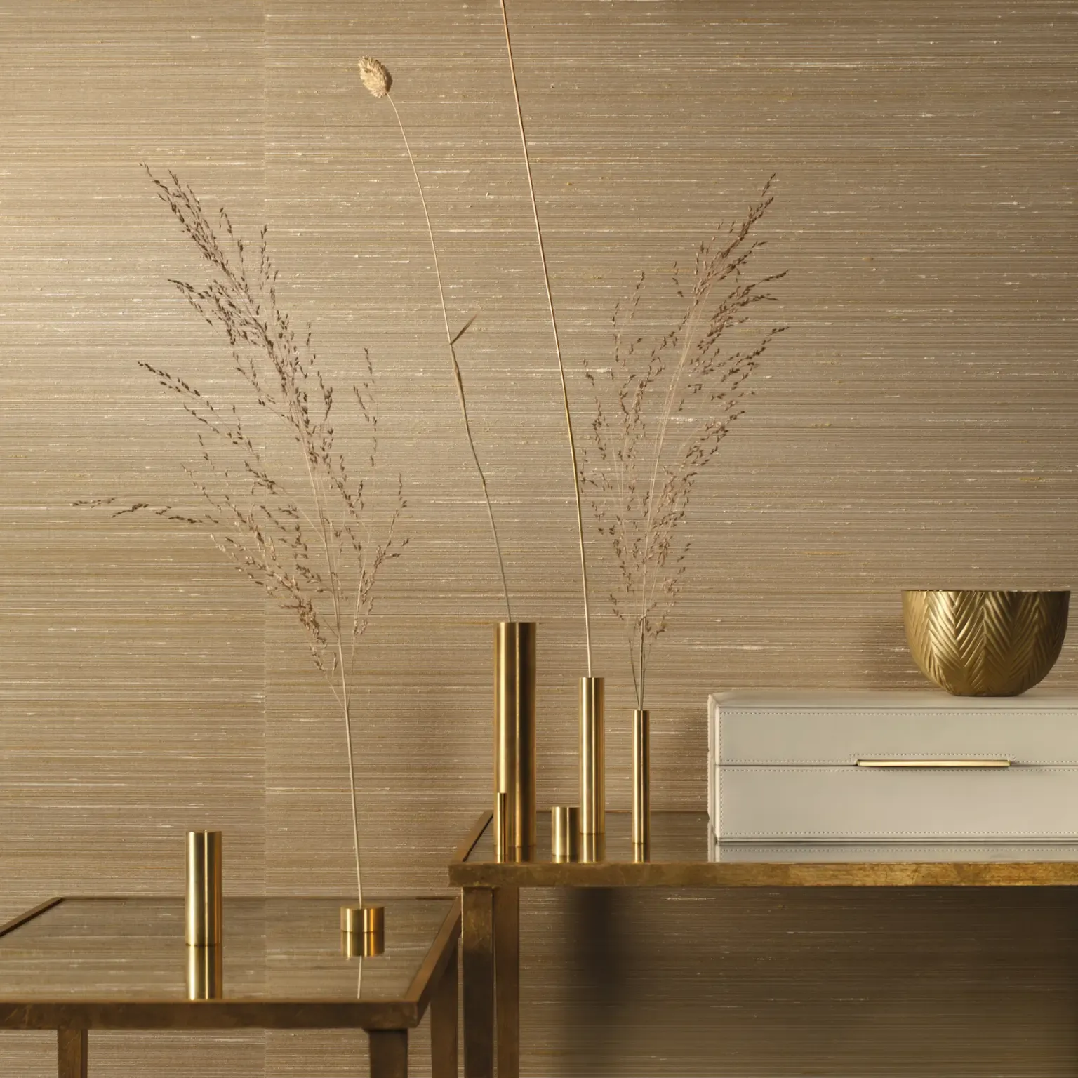 Elegant styled vases with dried grasses on textured background