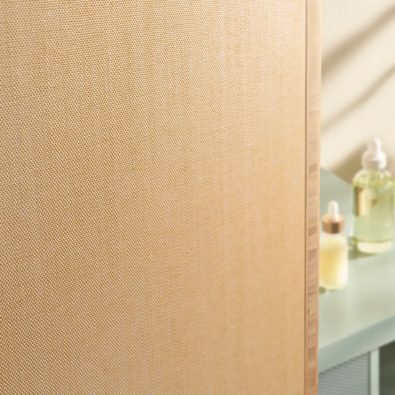 Textured light beige fabric panel with soft lighting
